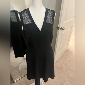 Black mini dress with back zip and lace style detail